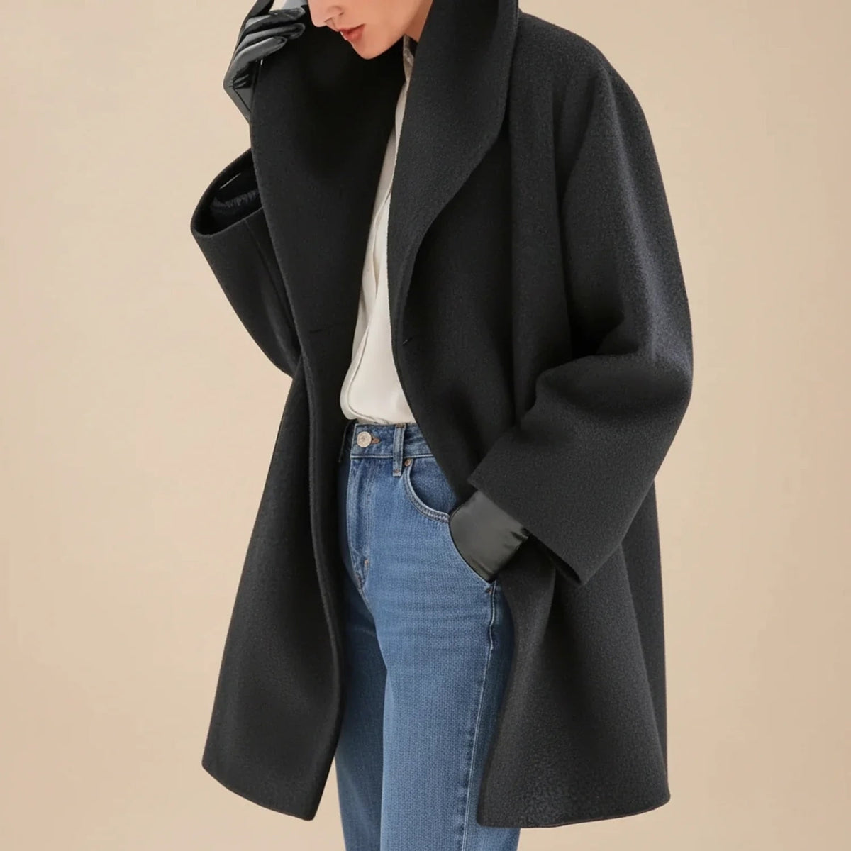 Woman wearing a black oversized A-line coat
