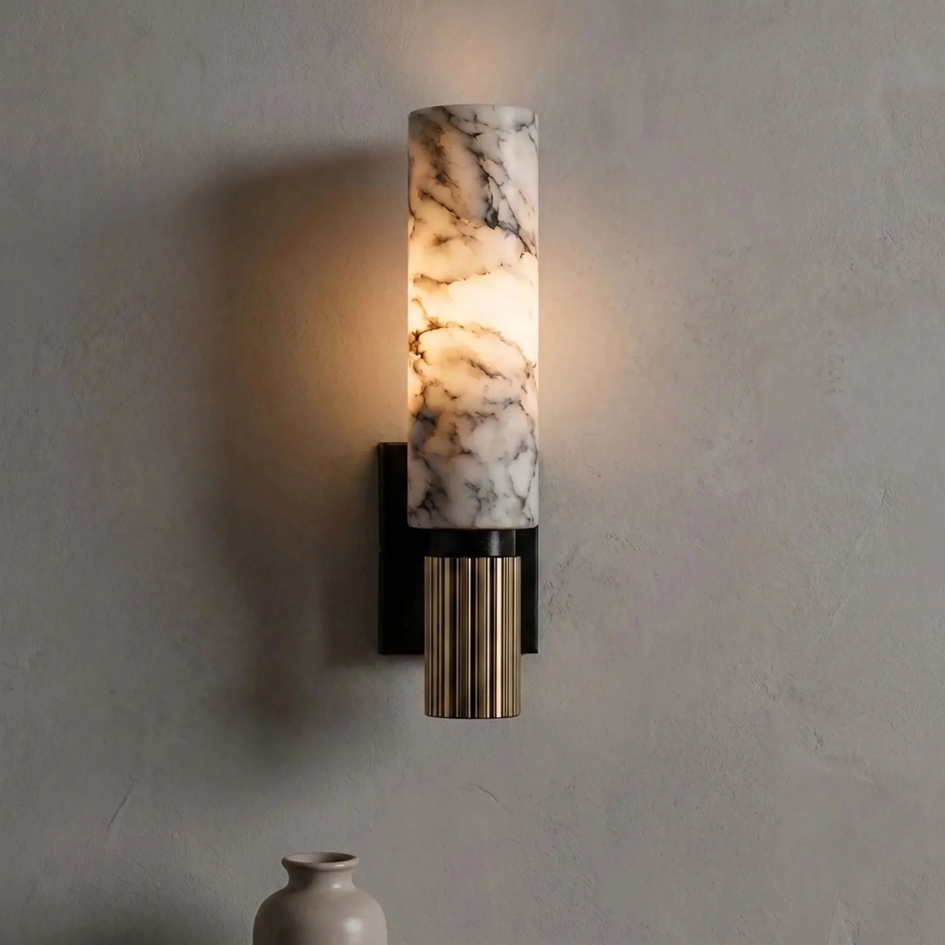 Cylindrical veined wall sconce mounted in an interior