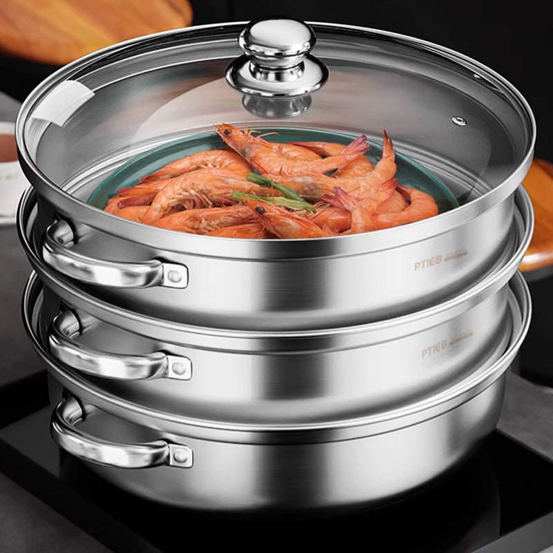 Stainless steel three tier steamer with glass lid, prawns steaming in the top tier