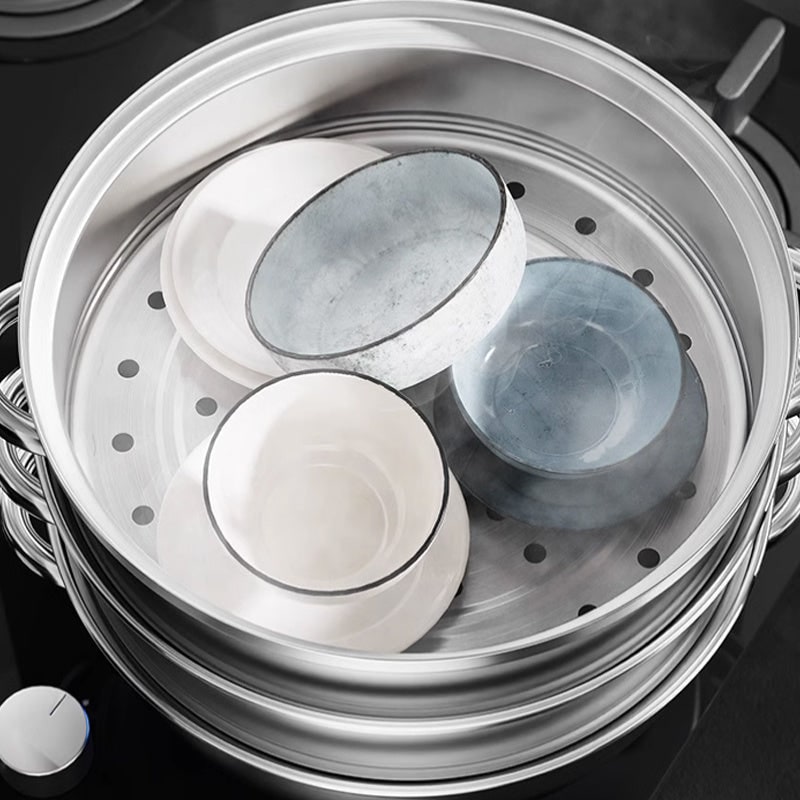 Top view into the perforated steamer tier holding small bowls