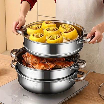 Hands lifting the top tier with buns above a tier of crab on an induction hob
