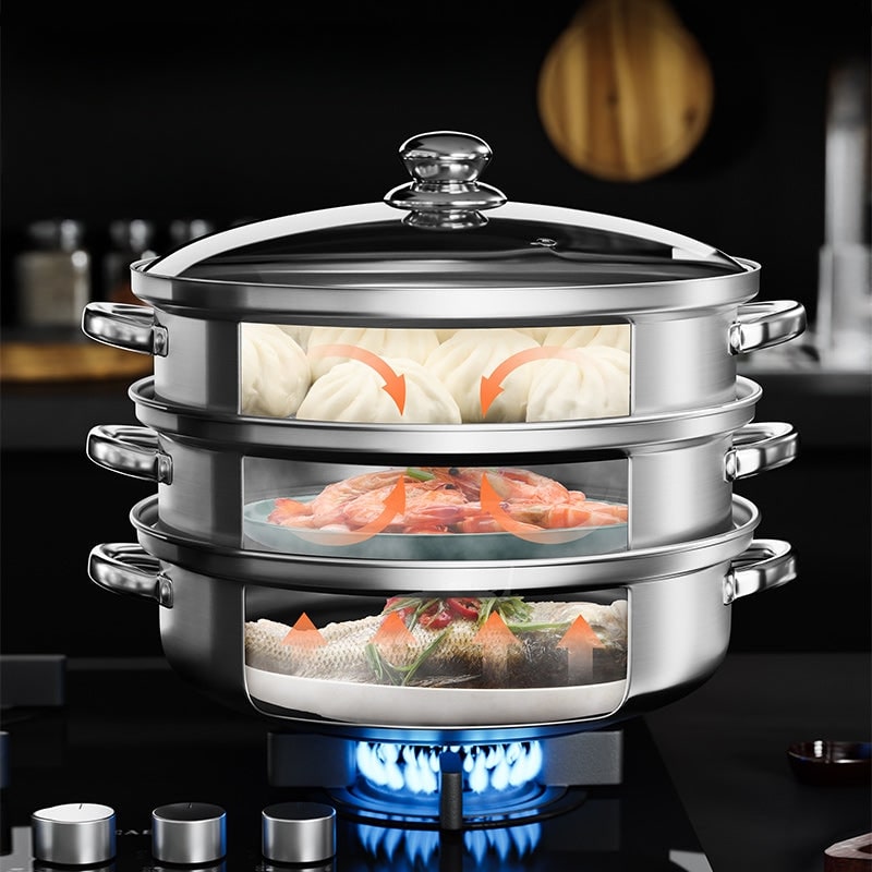 Stacked steamer on a gas burner with dumplings, prawns and fish on each level