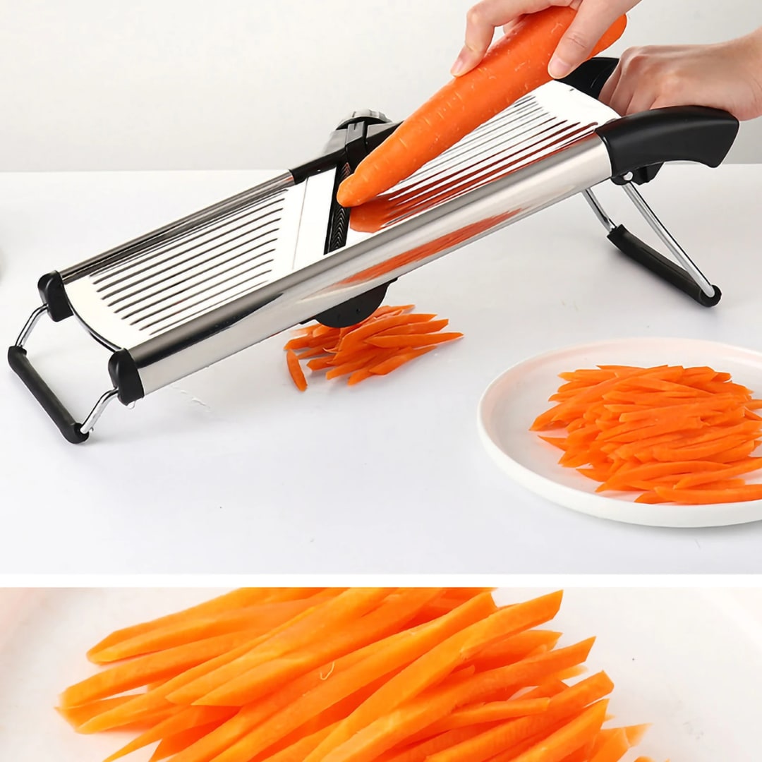 Carrot being cut into julienne strips on the stainless steel mandoline