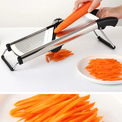 Carrot being cut into julienne strips on the stainless steel mandoline