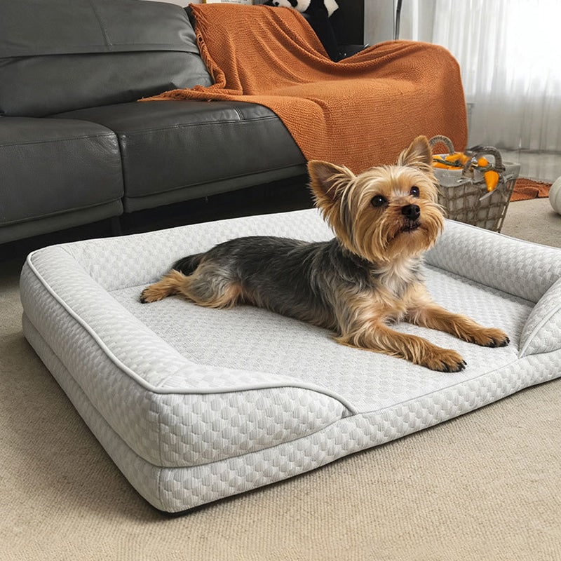 Cooling pet bed in light gray with a small dog