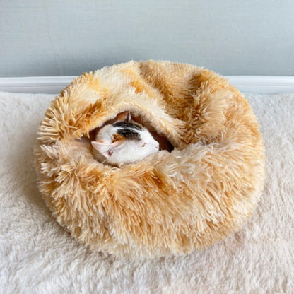 Yellow plush round pet bed with a cat inside