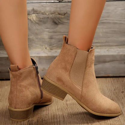 Beige Chelsea boots on wood floor