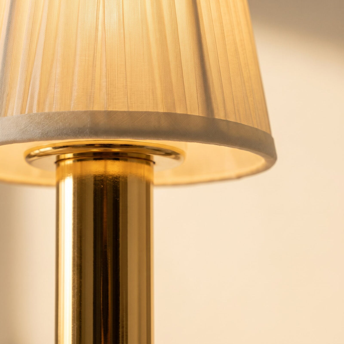 Close-up of the fabric shade of the cordless touch table lamp in gold