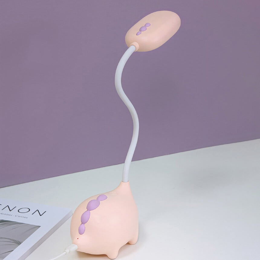 Pink lamp being switched on by hand
