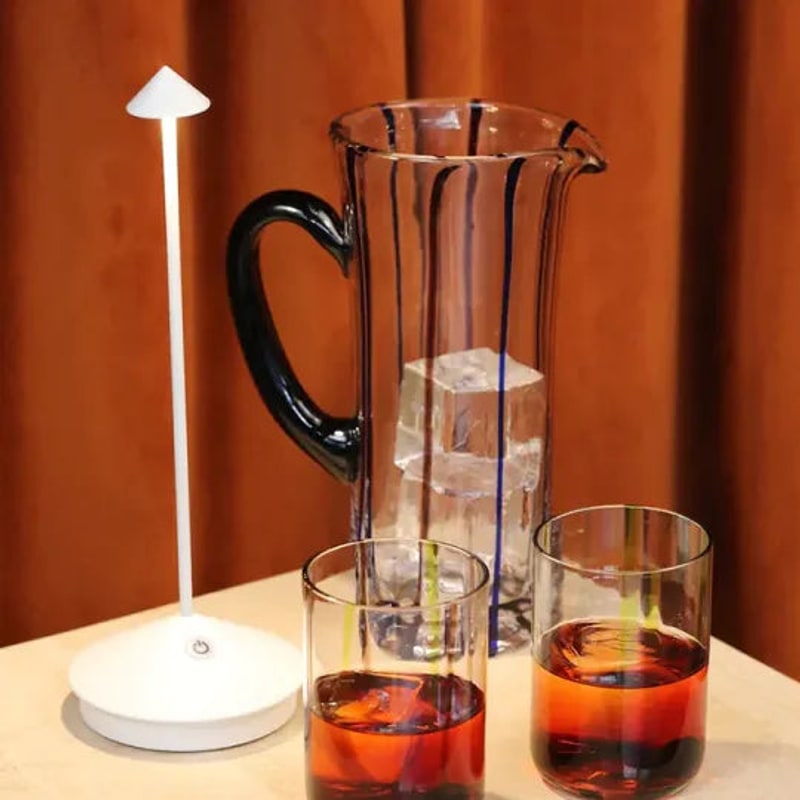 White lamp next to a jug and glasses