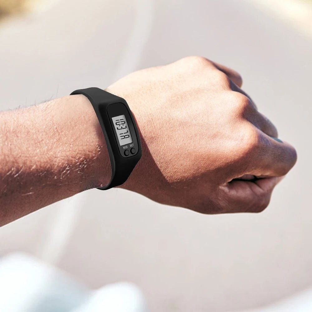 Black step counter watch worn on the wrist