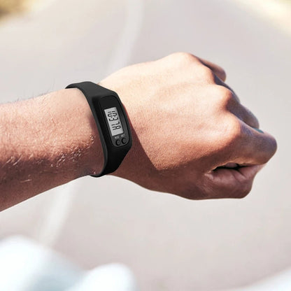 Black step counter watch worn on the wrist