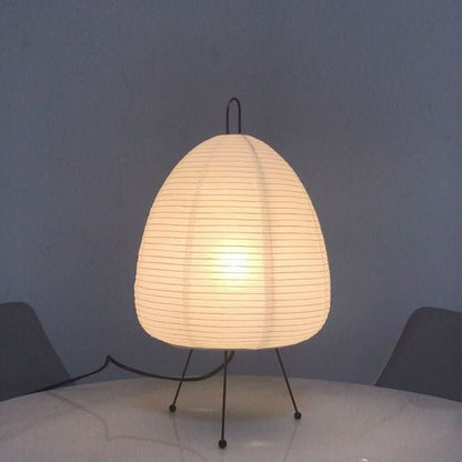 Rice paper table lamp switched on in a calm room