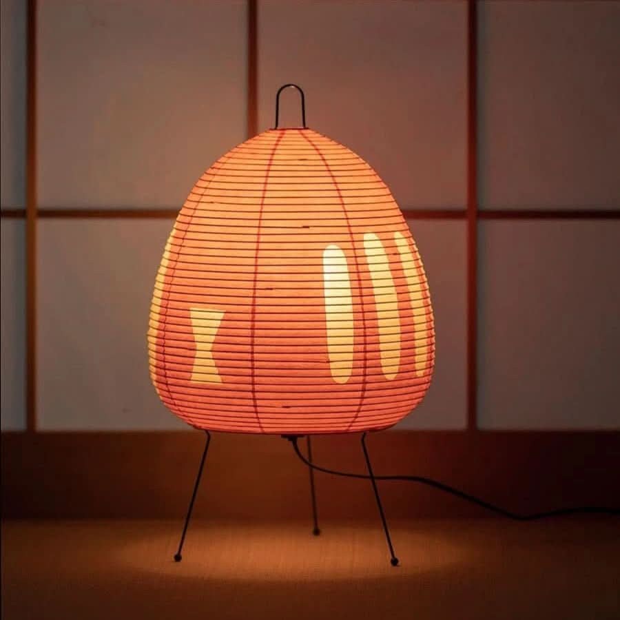 Orange Stripe rice paper table lamp glowing in the evening