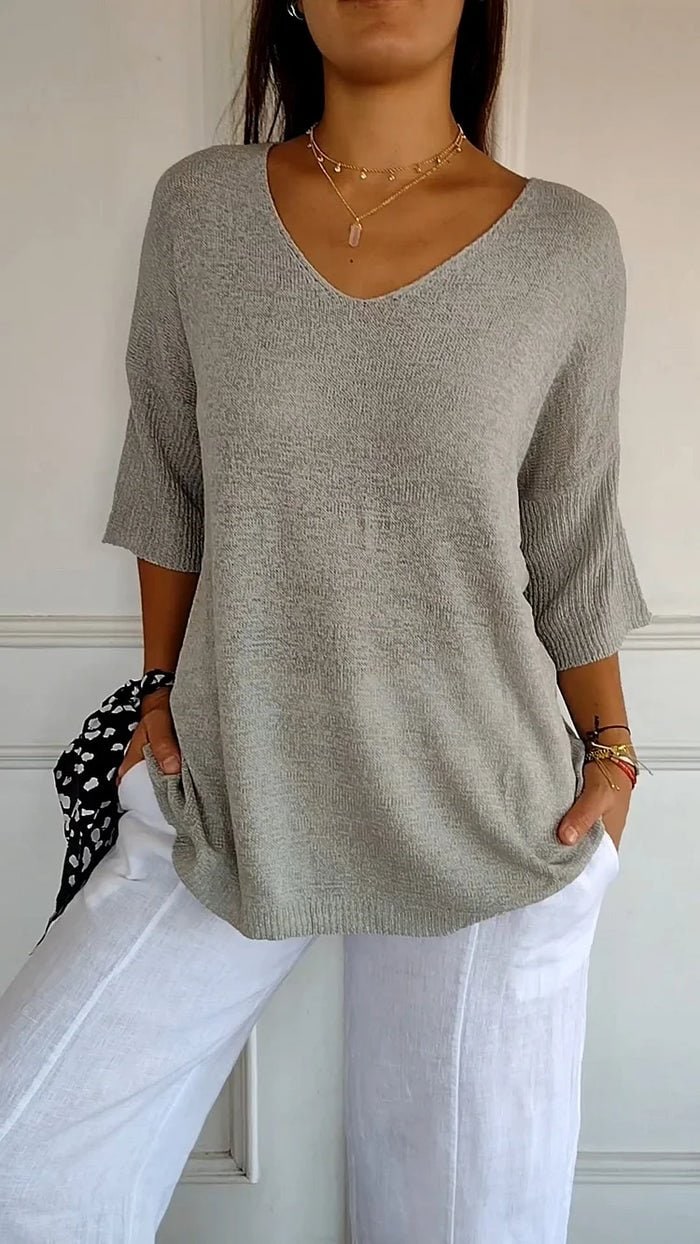 Women's grey V-neck knit sweater