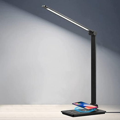 LED desk lamp charging a phone on its base