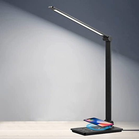 LED desk lamp charging a phone on its base