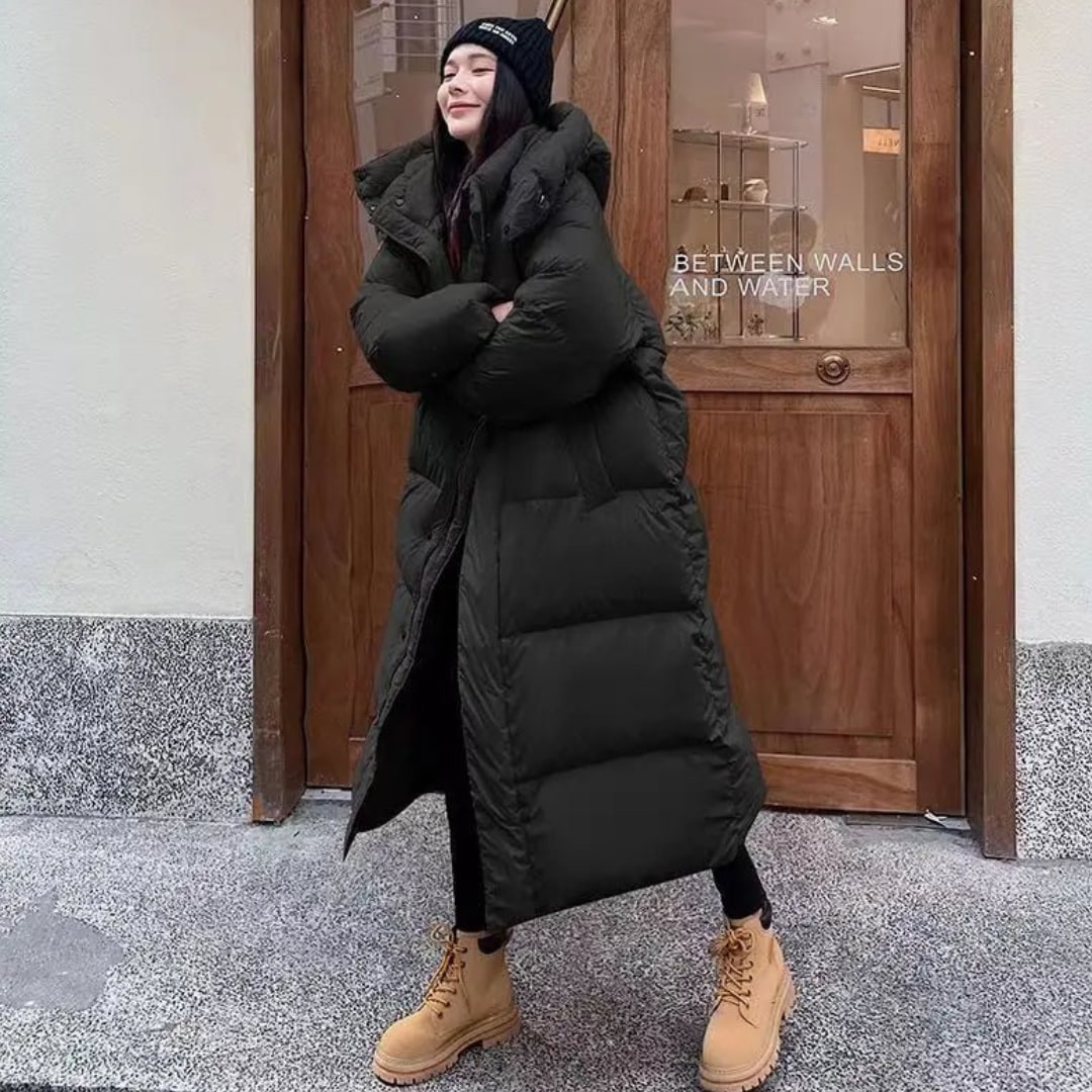 Woman wearing a long black hooded puffer jacket in winter