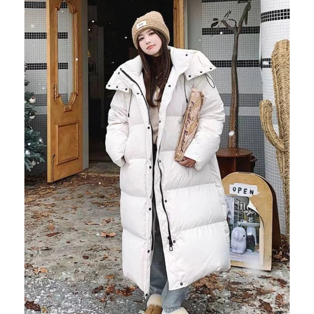 Long hooded puffer jacket styled with boots, front view