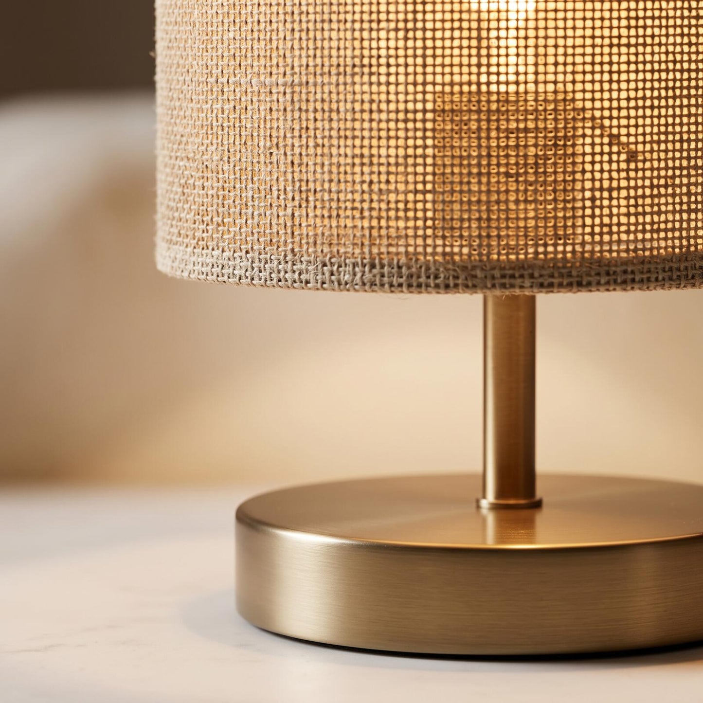 Close-up of the woven fabric shade and brass base