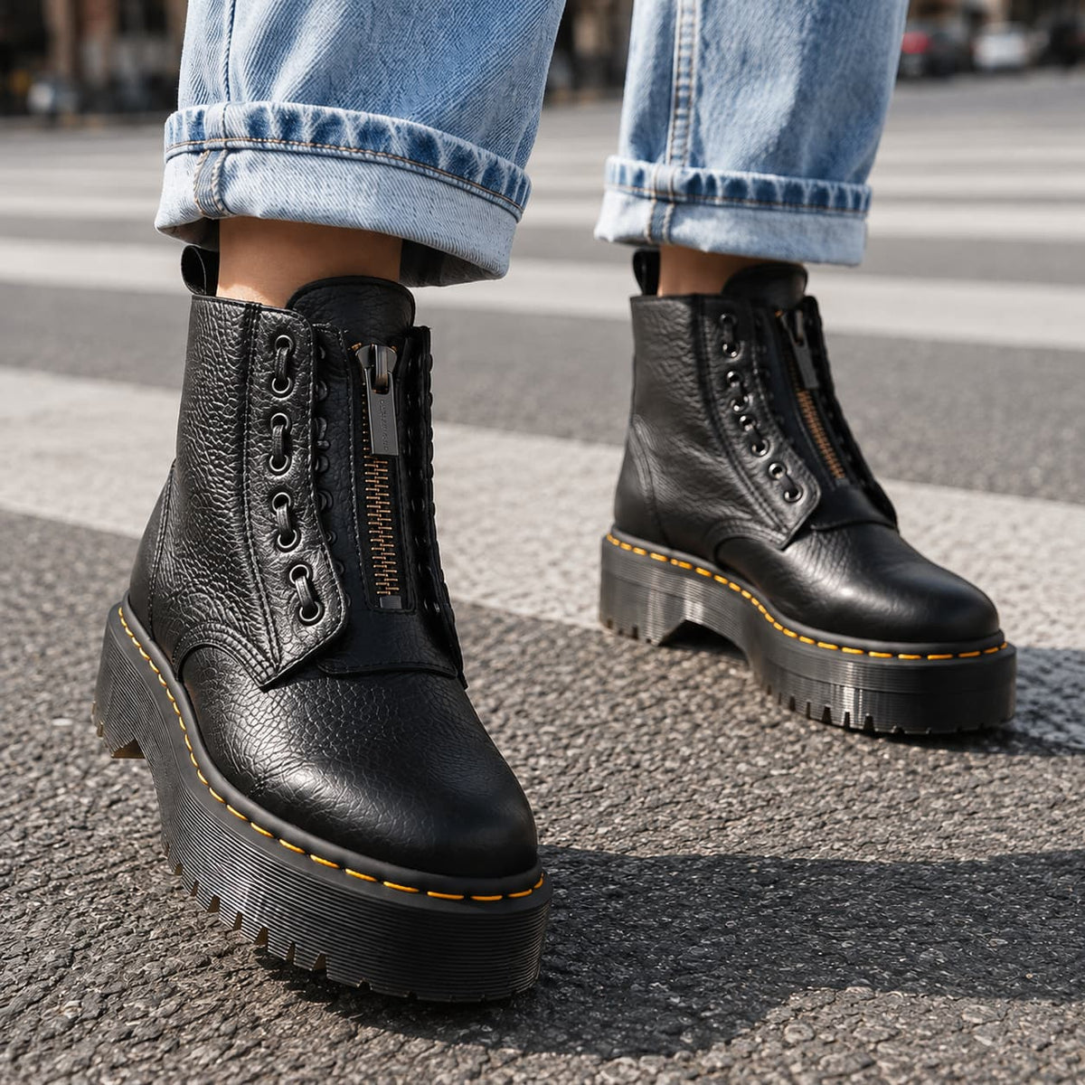Black platform ankle boots with chunky ridged sole and front zip