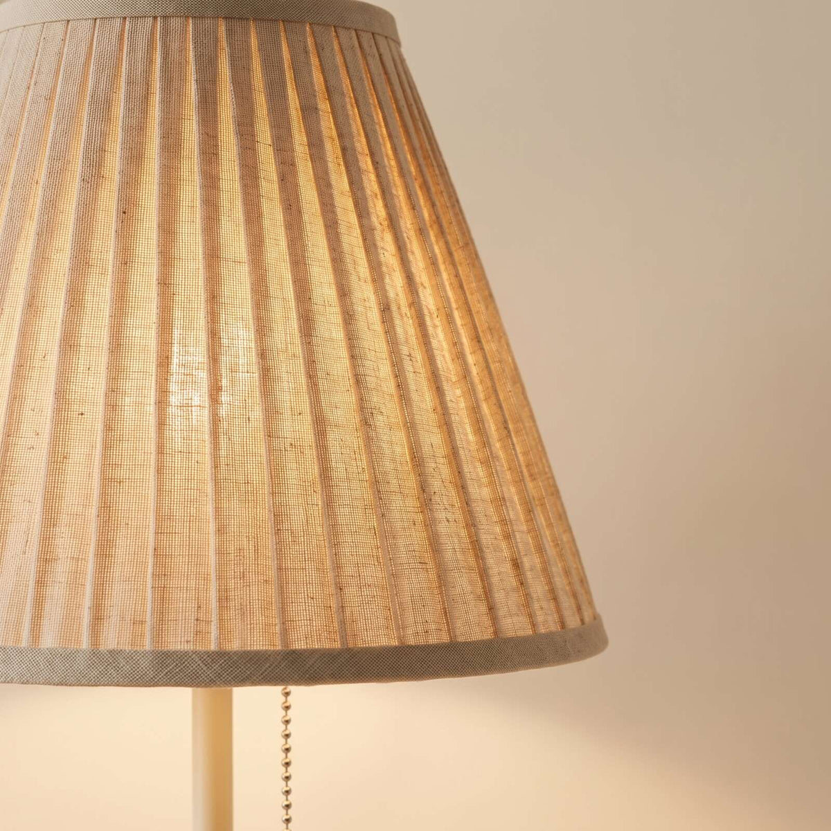 Close-up of the pleats in the natural fabric shade