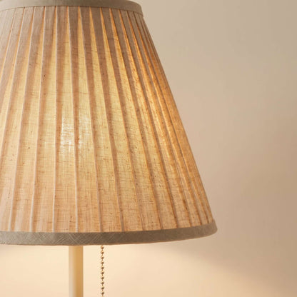 Close-up of the pleats in the natural fabric shade