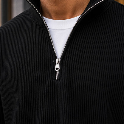 Close-up of the black ribbed knit and metal quarter zip