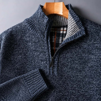 Close-up of the blue knit, quarter zip and plaid-lined collar