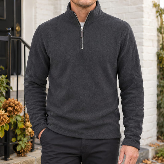 Men's grey quarter zip fleece sweater with a tall collar, worn with dark trousers