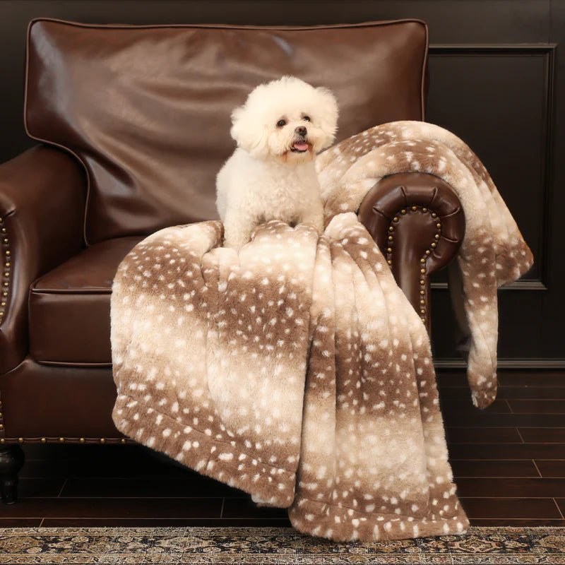 Deer print blanket on a leather armchair