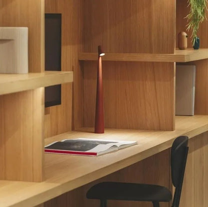 Red slim cordless LED table lamp on a wooden desk