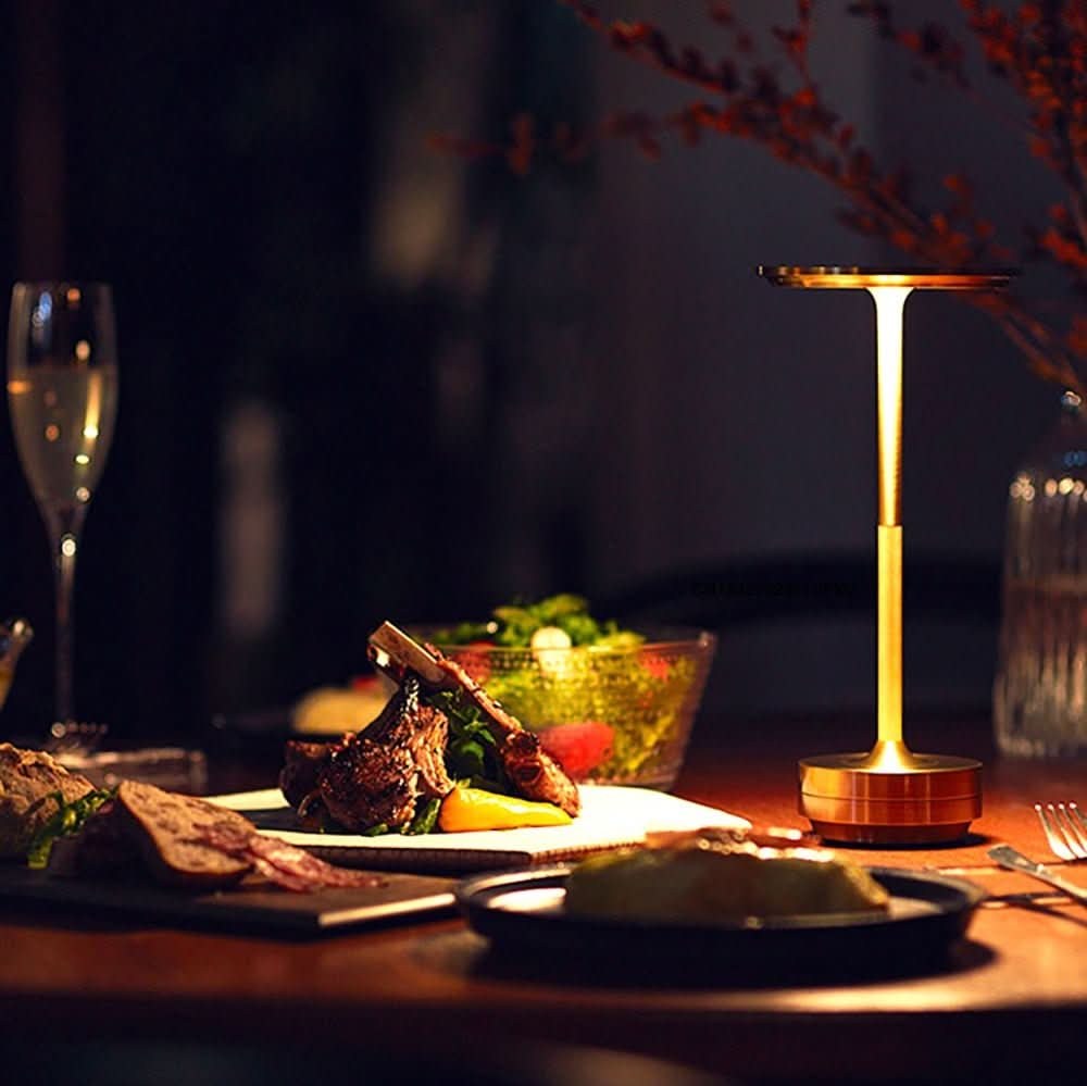 Disc LED table lamp on a dinner table in the evening