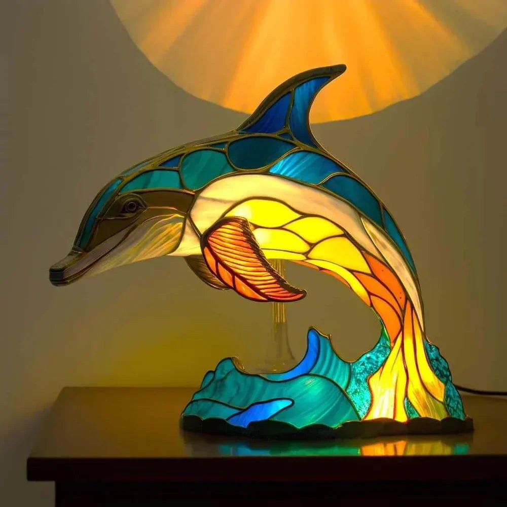 Stained glass dolphin table lamp switched on
