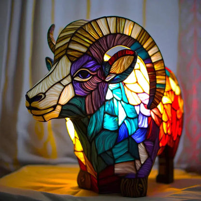 Stained glass ram table lamp switched on