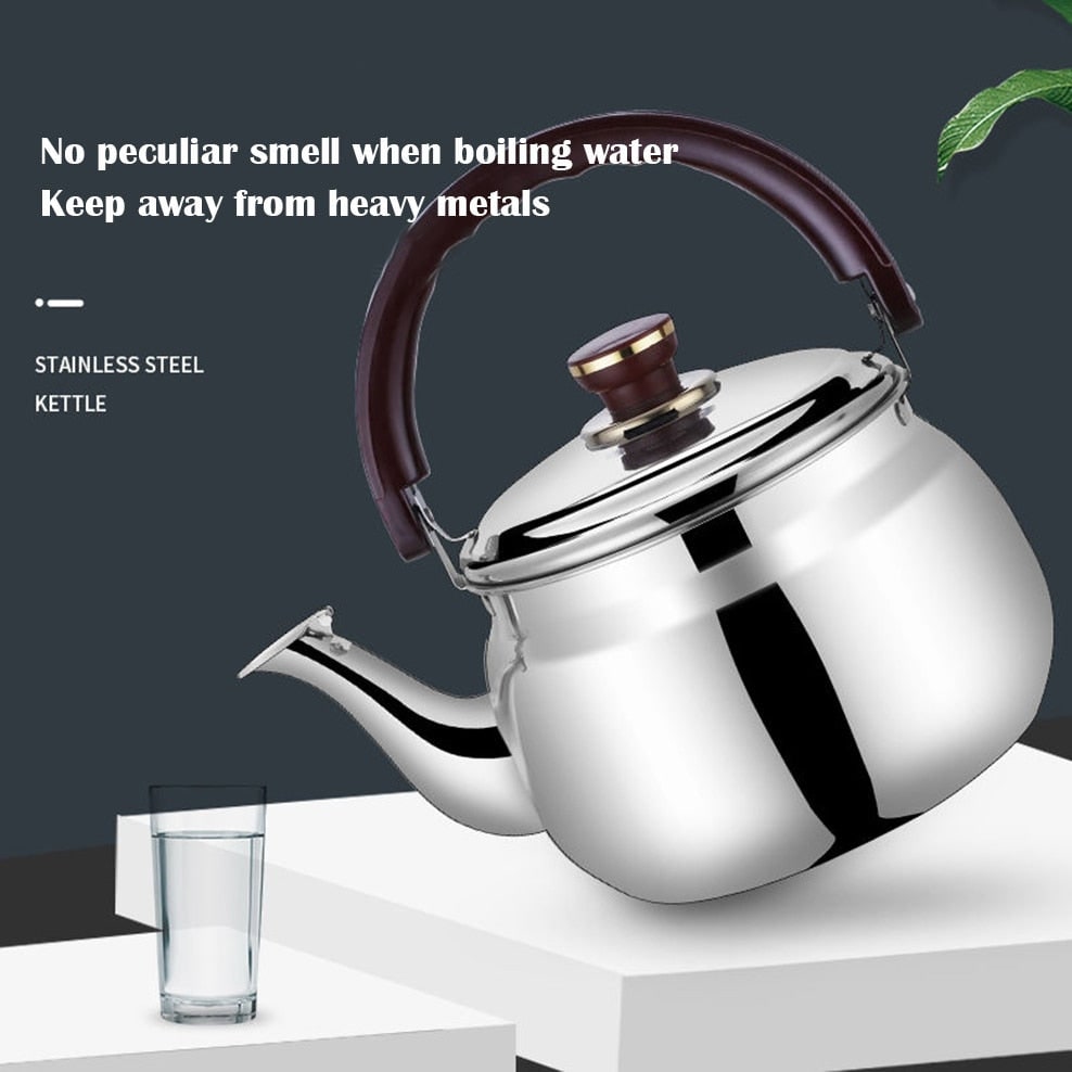 Stainless steel kettle next to a glass of water