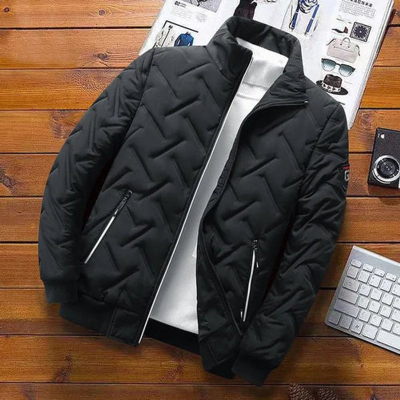 Black quilted jacket laid flat on a wooden table