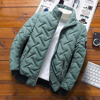 Green quilted jacket laid flat on a wooden table