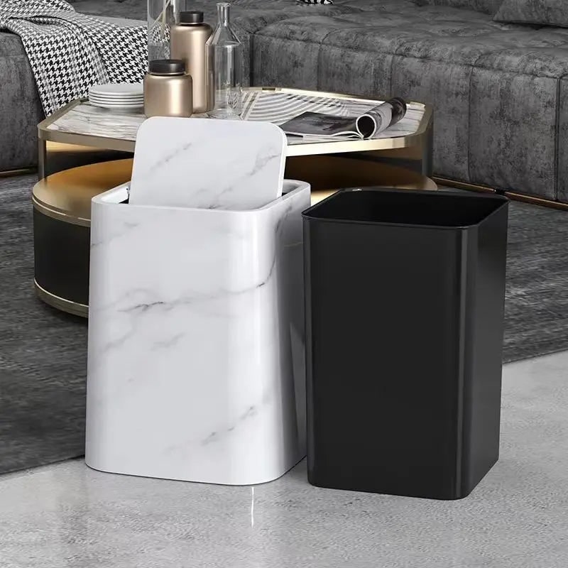 White and black trash cans side by side in a living room