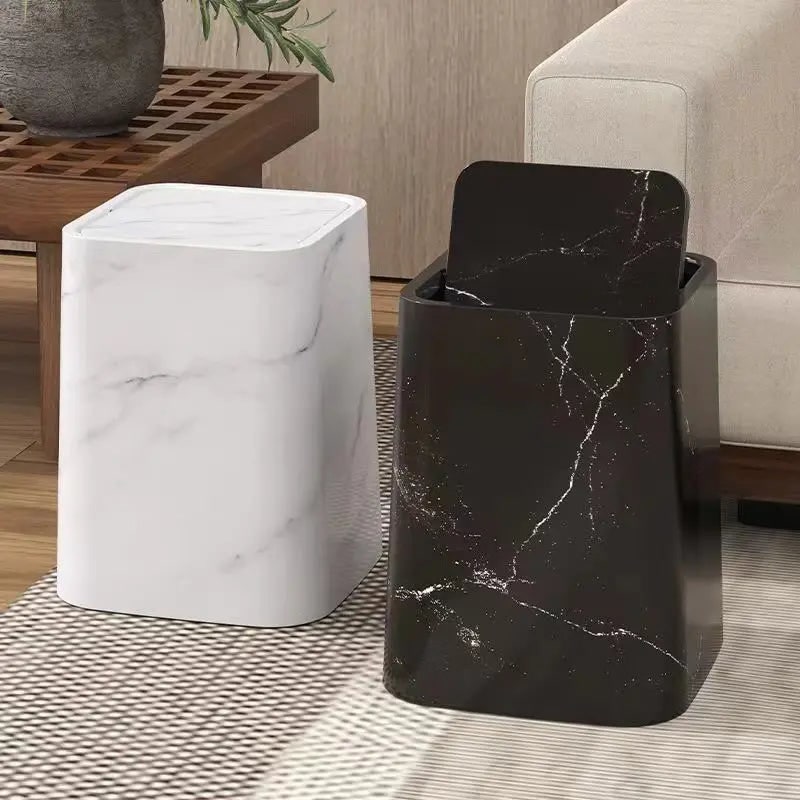 White and black marble trash cans next to each other