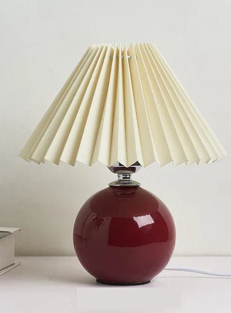 Pleated table lamp with wine red base and beige shade