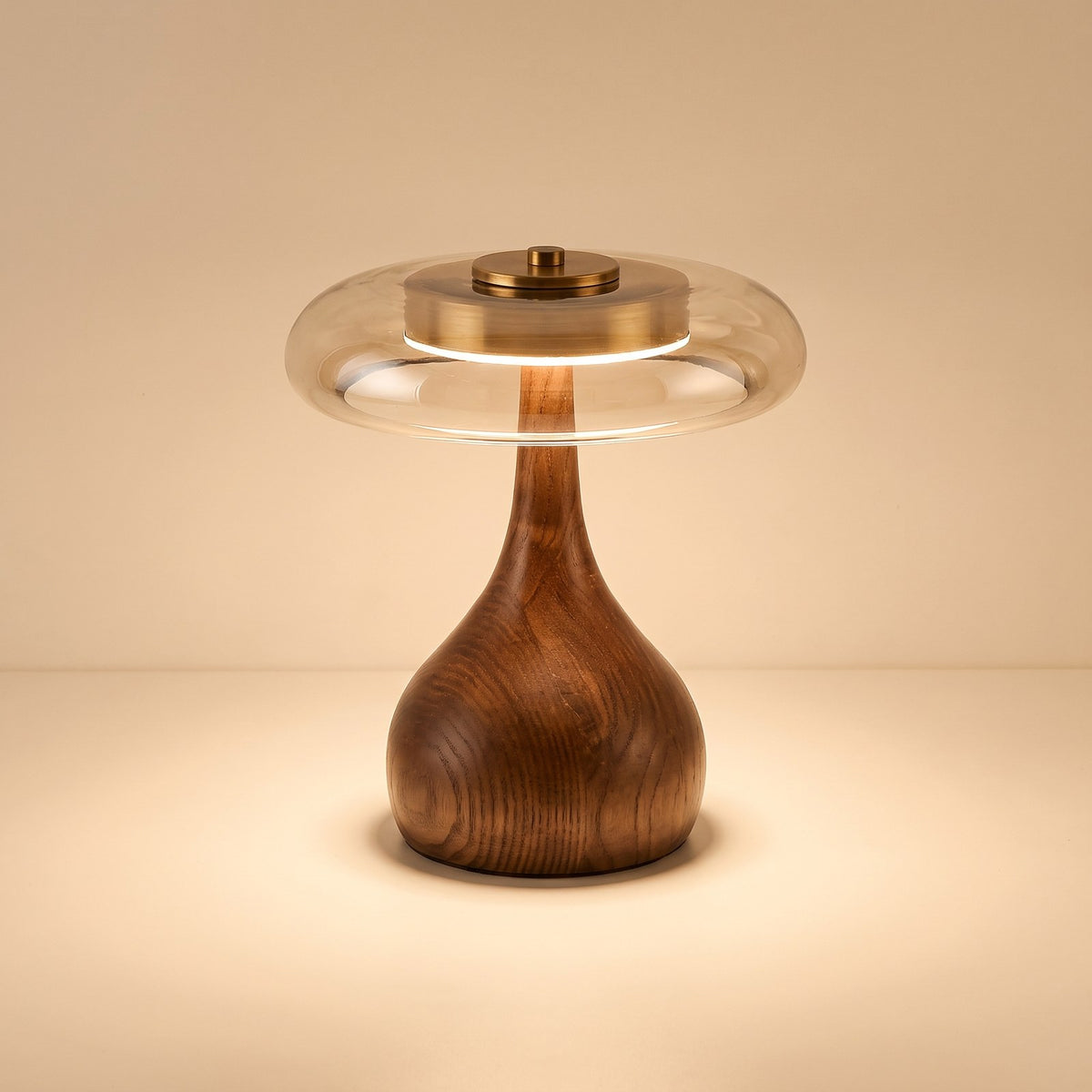 Glass disc LED table lamp with rounded dark wooden base