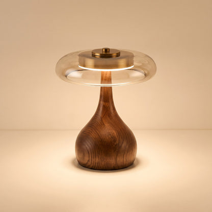Glass disc LED table lamp with rounded dark wooden base