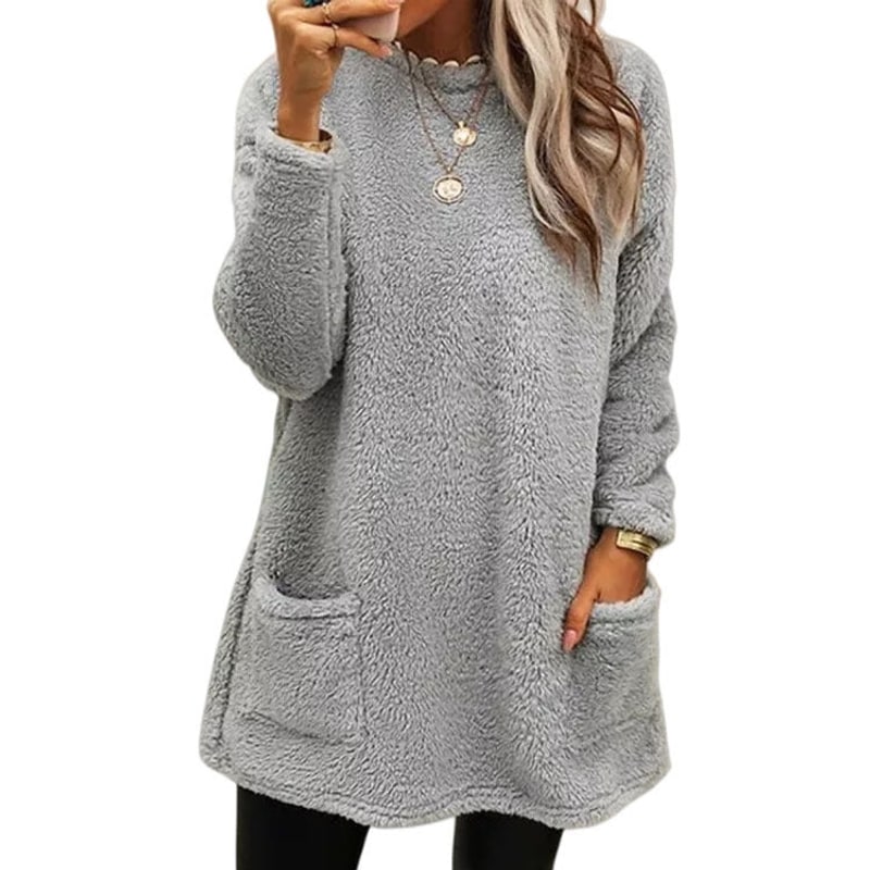 Women's grey fleece pullover with front pockets, worn with black leggings
