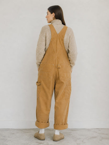 Beige canvas bib overalls, back view