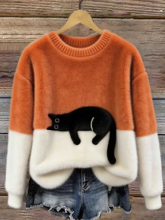 Orange and white cat print sweater on a hanger