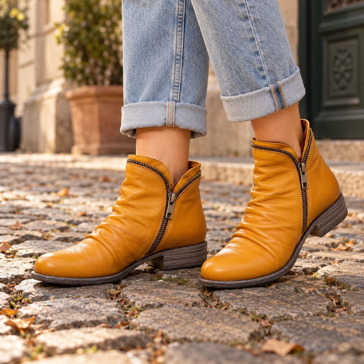 Yellow ankle boots on cobblestones