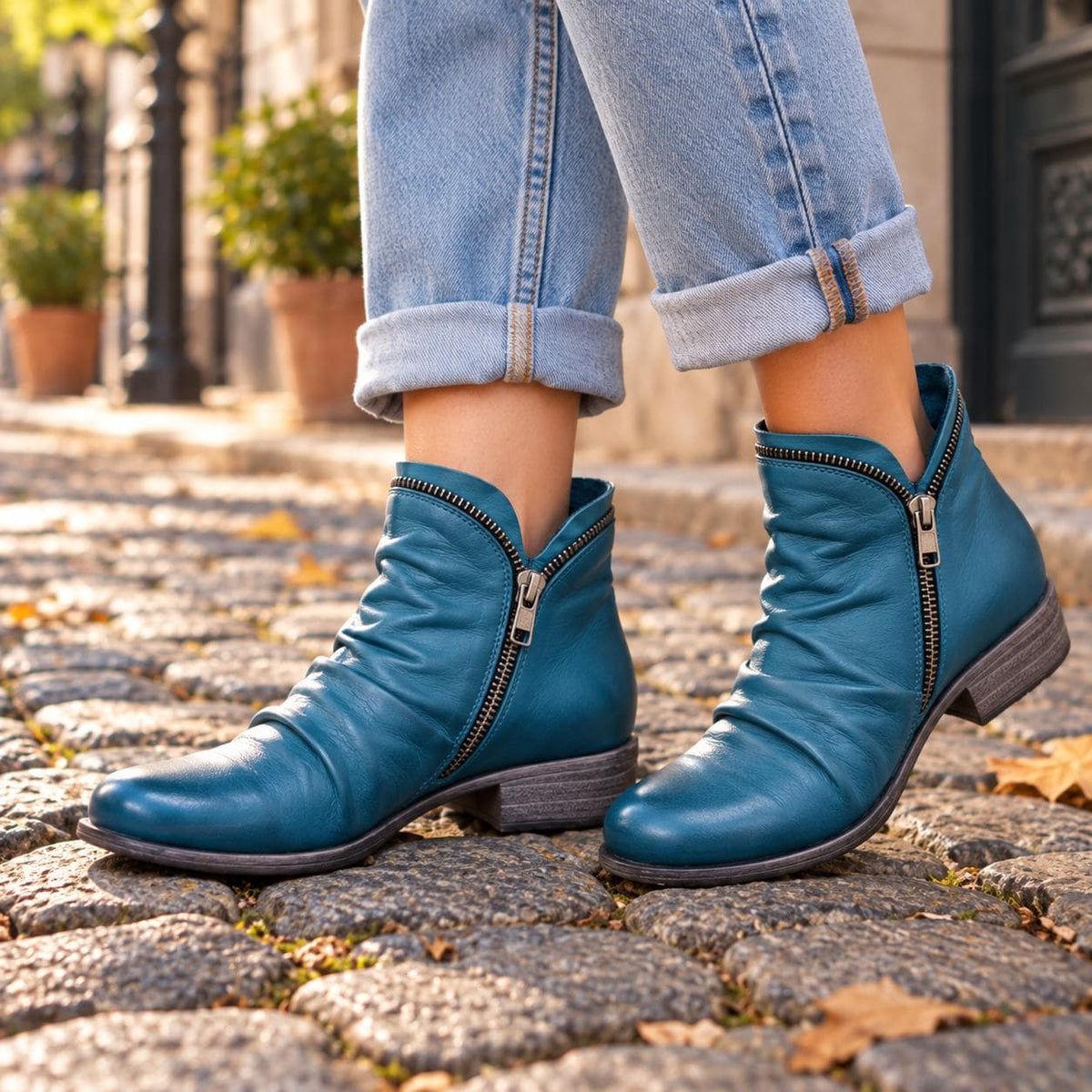 Blue ankle boots on cobblestones