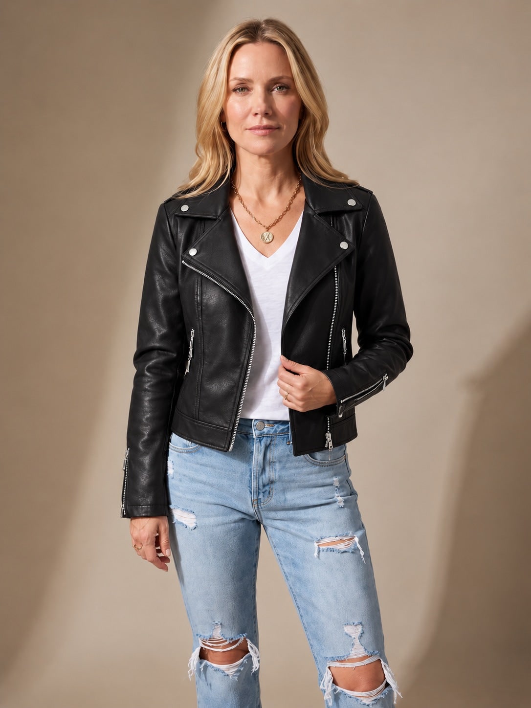 Woman wearing a black faux leather moto jacket