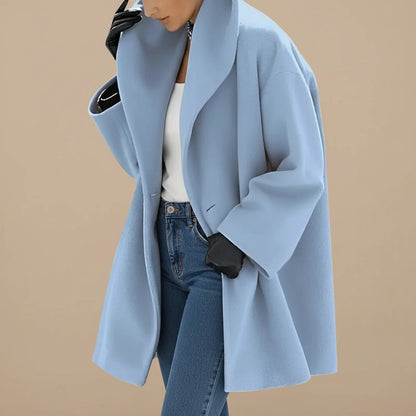 Woman wearing a light blue oversized A-line coat